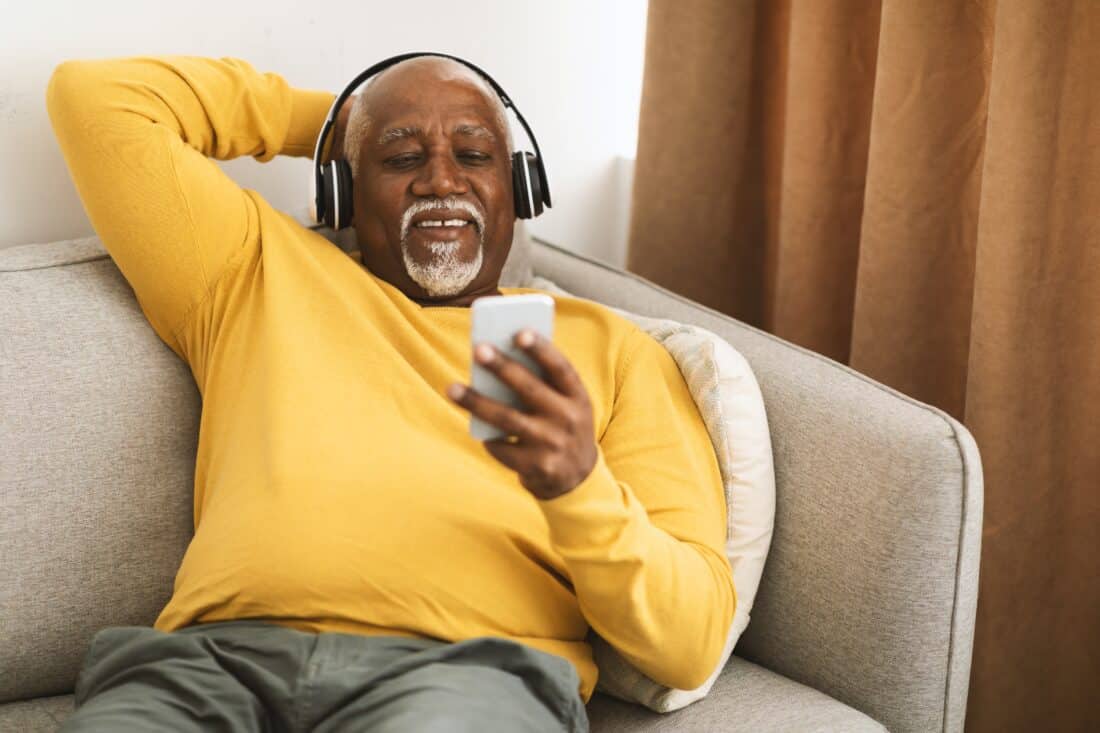 Senior,African,American,Man,Listening,To,Music,On,Smartphone,Sitting