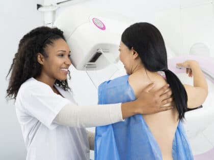 Happy,Doctor,Assisting,Woman,Undergoing,Mammogram,X ray,Test