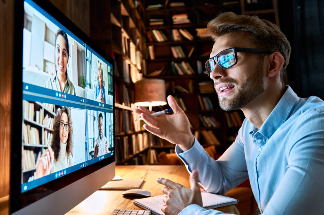 Young,Business,Man,Talking,With,Diverse,Colleagues,In,Virtual,Video