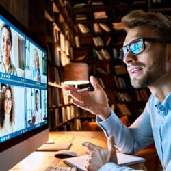 Young,Business,Man,Talking,With,Diverse,Colleagues,In,Virtual,Video